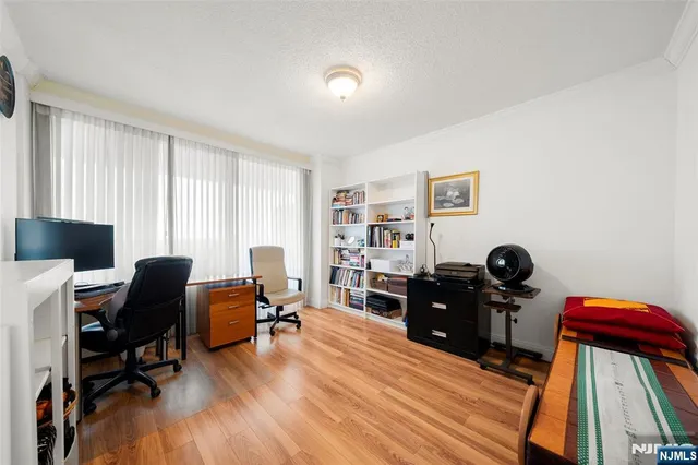 a view of a workspace with furniture and a window