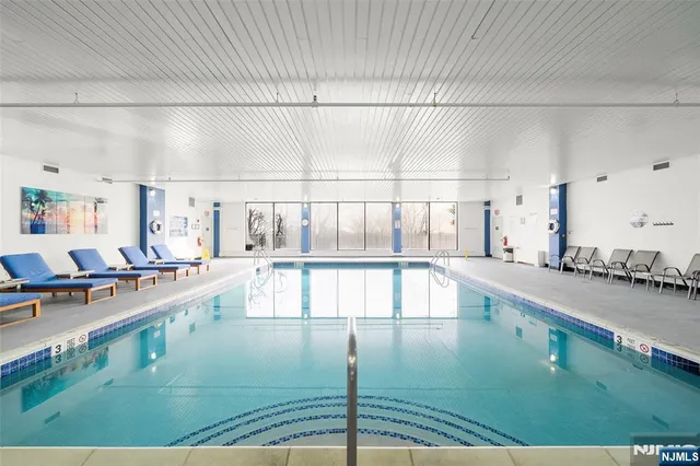 a large white kitchen with wooden floor