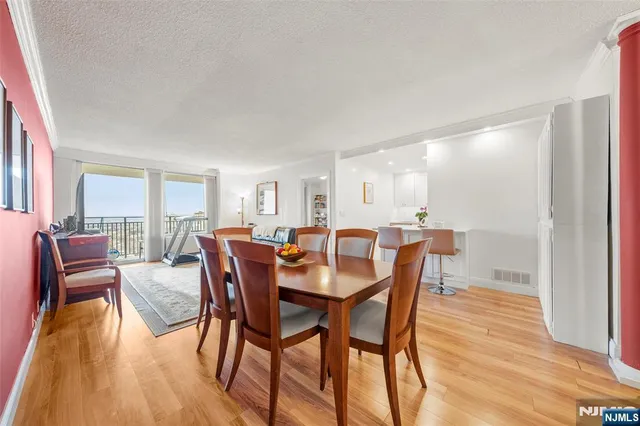 a dining room with furniture and wooden floor