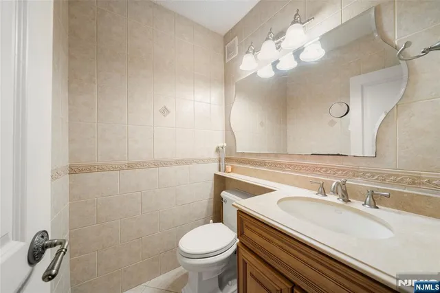 a bathroom with a sink a toilet and a mirror