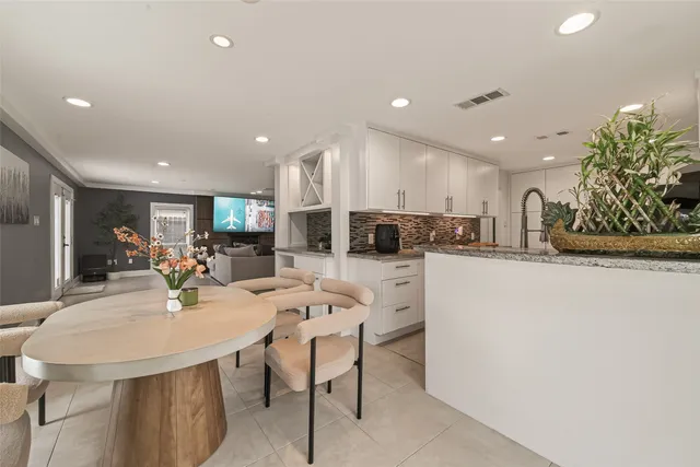 a kitchen with a sink and white cabinets