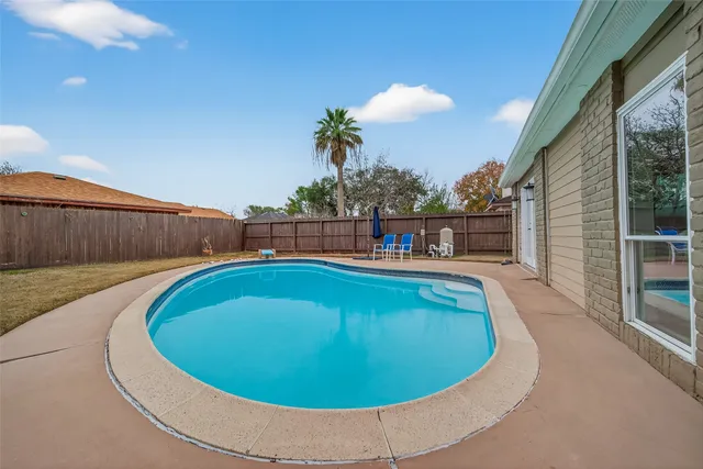 a view of a patio with a table and chairs