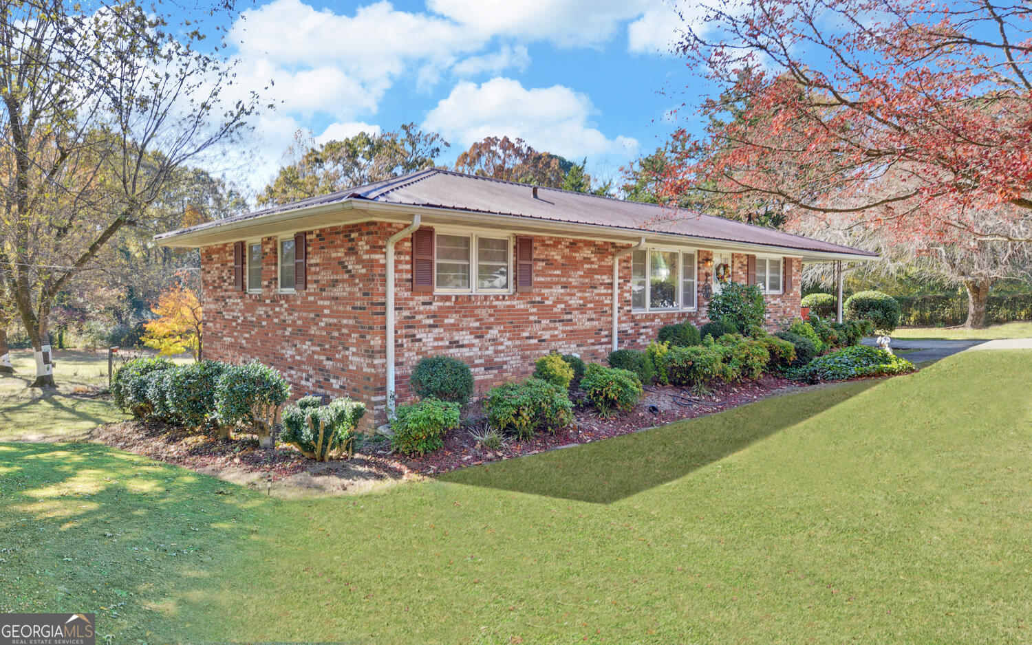 586 Collins Road Toccoa, GA 30577 - Photo 1 of 52 a front view of a house with a garden and plants