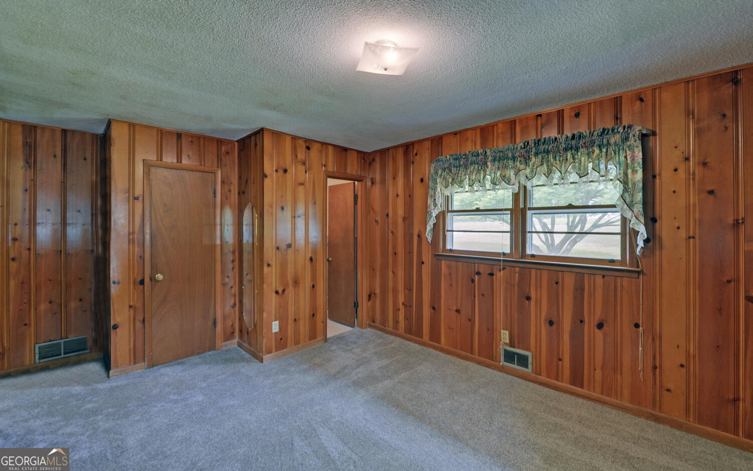 586 Collins Road Toccoa, GA 30577 - Photo 14 of 52 an empty room with a window and doors