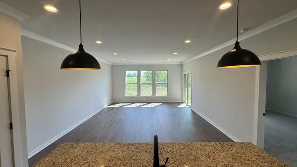 a view of a living room and a ceiling fan