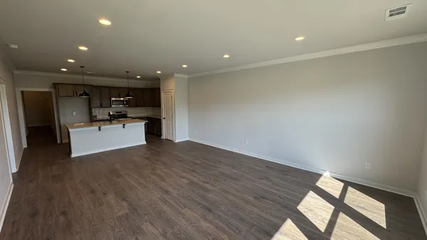 a view of kitchen with sink and refrigerator
