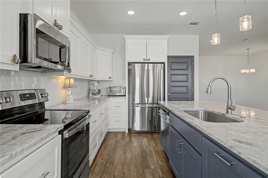 2406 Lightfoot Lane Bryan, TX 77803 - Photo 1 of 38 a kitchen with stainless steel appliances granite countertop a refrigerator sink and stove