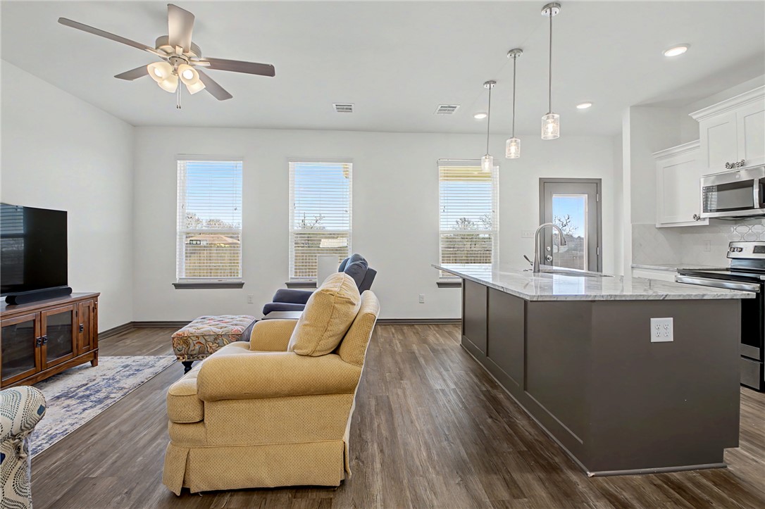 2406 Lightfoot Lane Bryan, TX 77803 - Photo 12 of 38 a living room with furniture and a flat screen tv