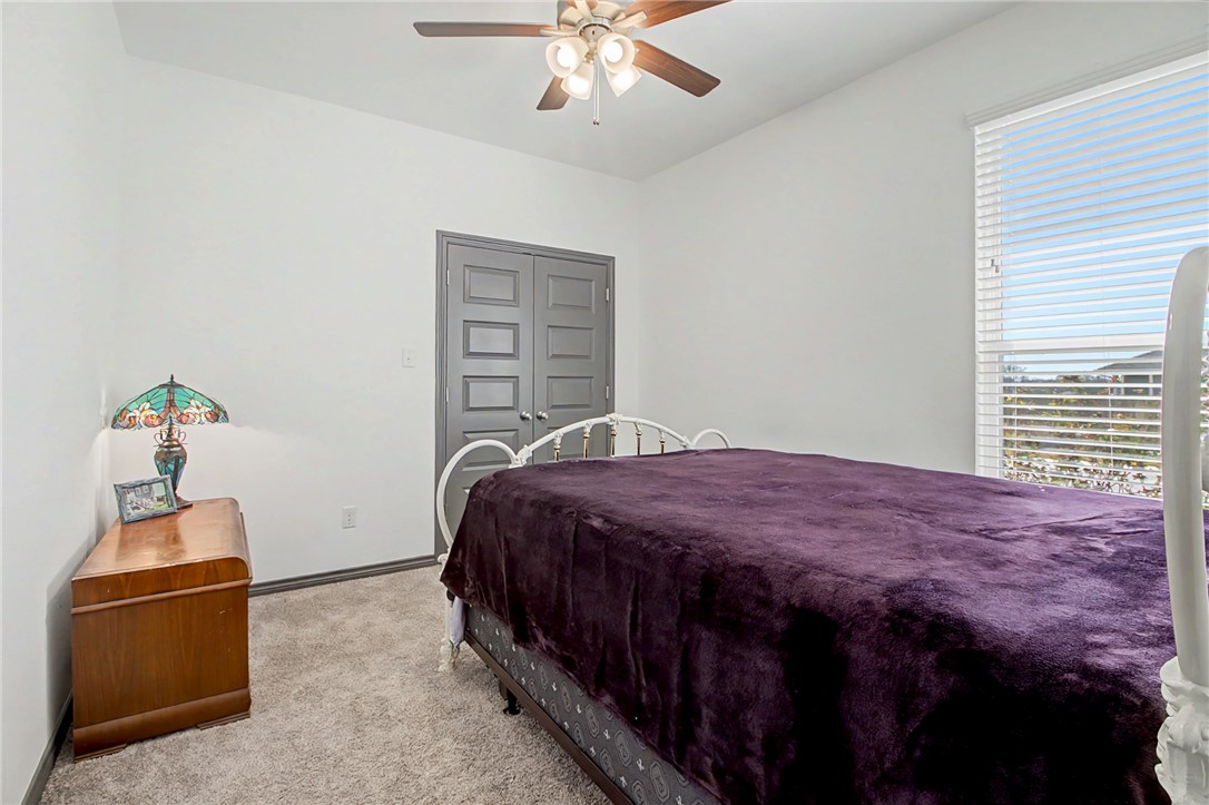 2406 Lightfoot Lane Bryan, TX 77803 - Photo 14 of 38 a bedroom with a bed and a chandelier