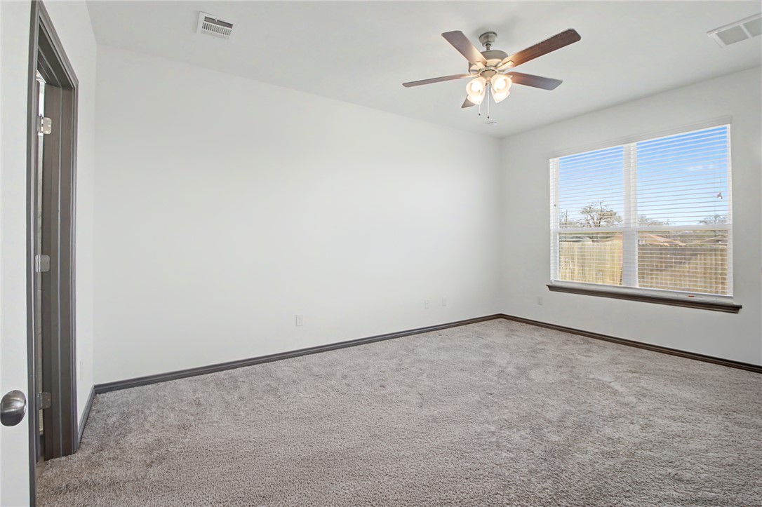 2406 Lightfoot Lane Bryan, TX 77803 - Photo 17 of 38 an empty room with windows and fan