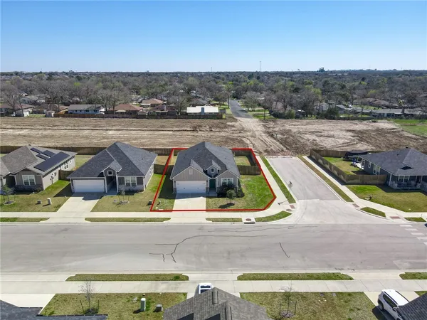 an aerial view of a house with a yard