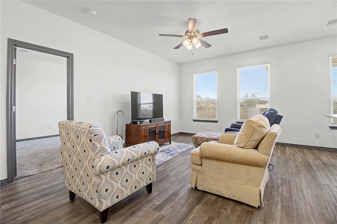 2406 Lightfoot Lane Bryan, TX 77803 - Photo 22 of 38 a living room with furniture a flat screen tv and a window