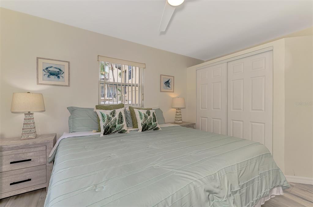 446 Canal Road, Unit 5 Sarasota, FL 34242 - Photo 16 of 64 a bed room with a bed and a night stand