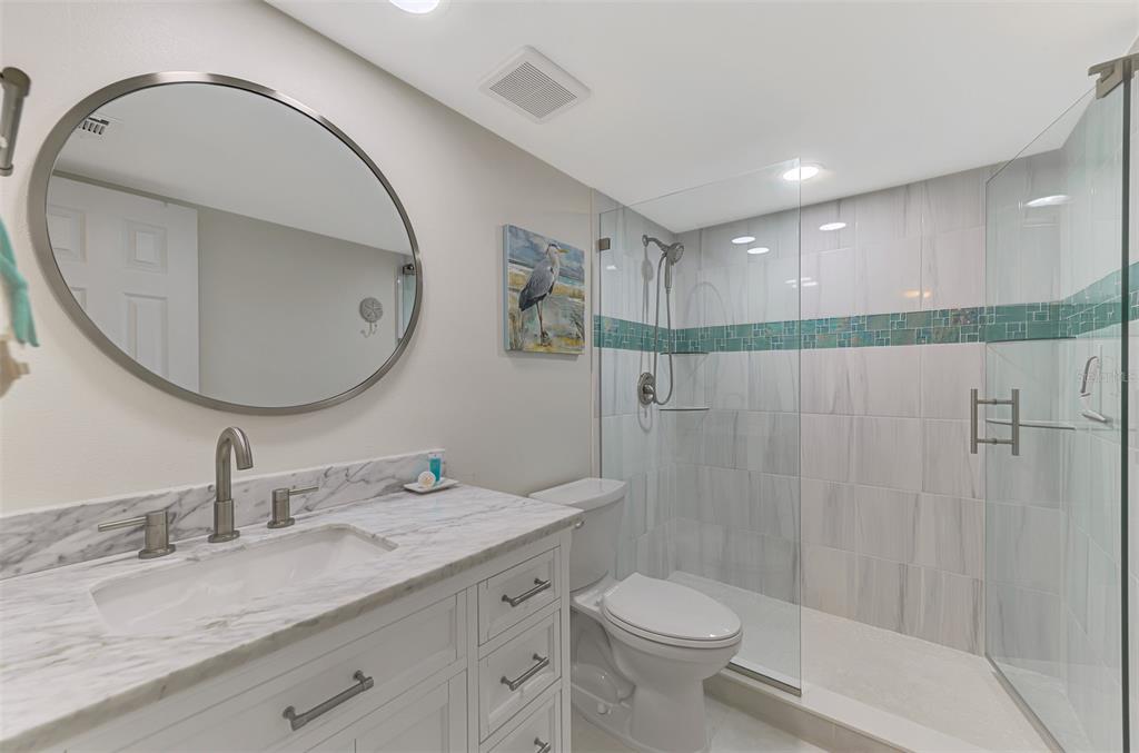 446 Canal Road, Unit 5 Sarasota, FL 34242 - Photo 18 of 64 a bathroom with a granite countertop sink a toilet and a mirror