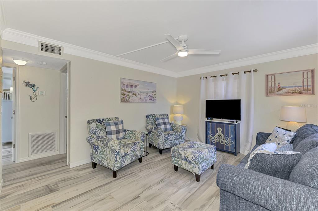446 Canal Road, Unit 5 Sarasota, FL 34242 - Photo 4 of 64 a living room with furniture and a flat screen tv
