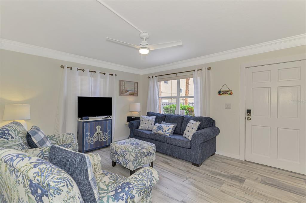 446 Canal Road, Unit 5 Sarasota, FL 34242 - Photo 5 of 64 a living room with furniture a flat screen tv and a couch