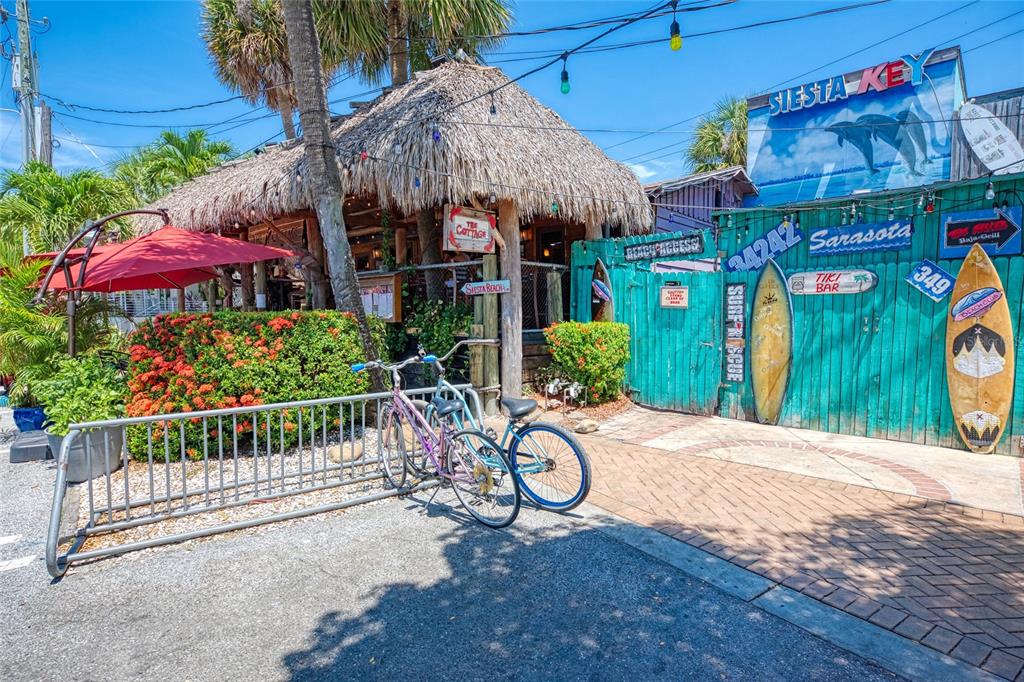 446 Canal Road, Unit 5 Sarasota, FL 34242 - Photo 62 of 64 a view of a patio with a table and chairs under an umbrella