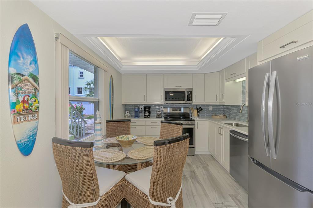 446 Canal Road, Unit 5 Sarasota, FL 34242 - Photo 10 of 64 a living room with stainless steel appliances furniture a refrigerator and a kitchen view