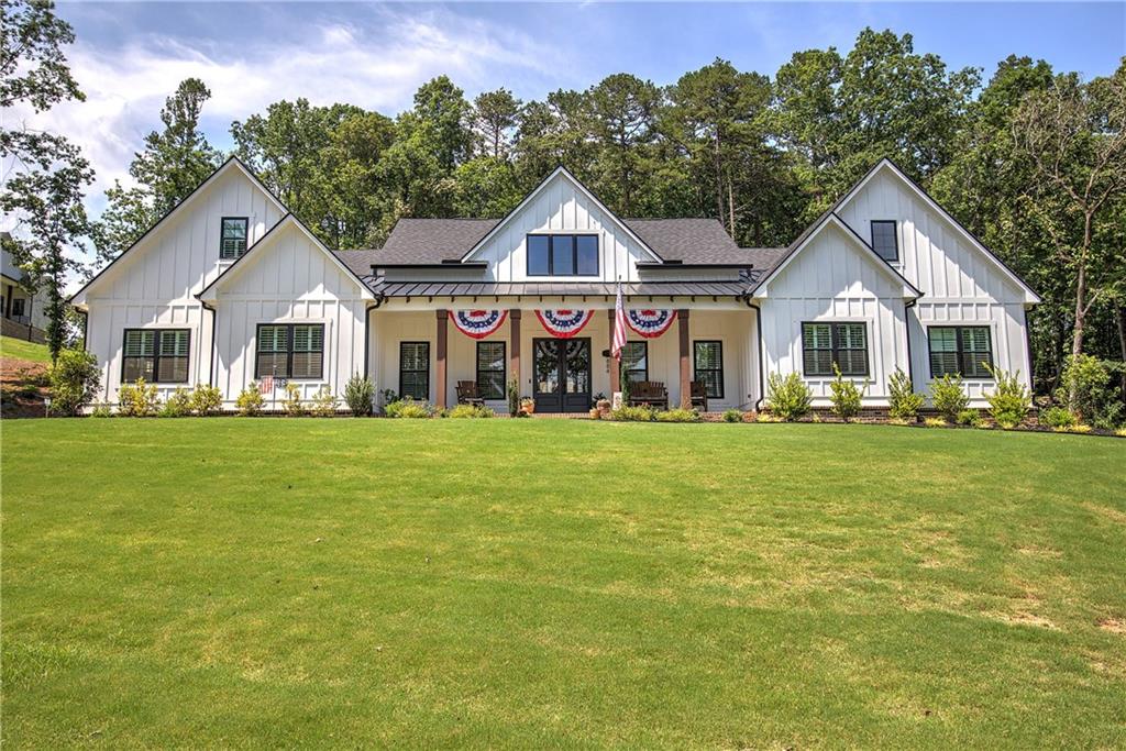 884 Oxford Road Ball Ground, GA 30107 - Photo 1 of 1 a front view of a house with a garden and trees