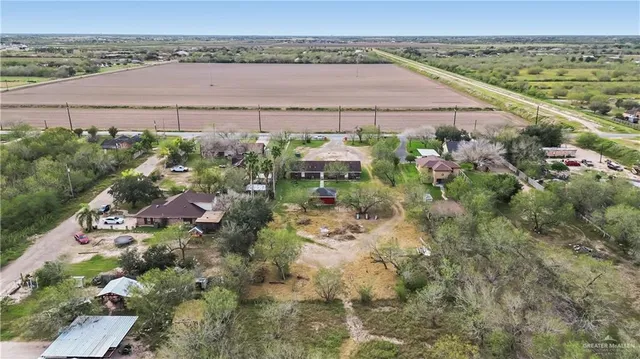 an aerial view of a house with a yard and lake view