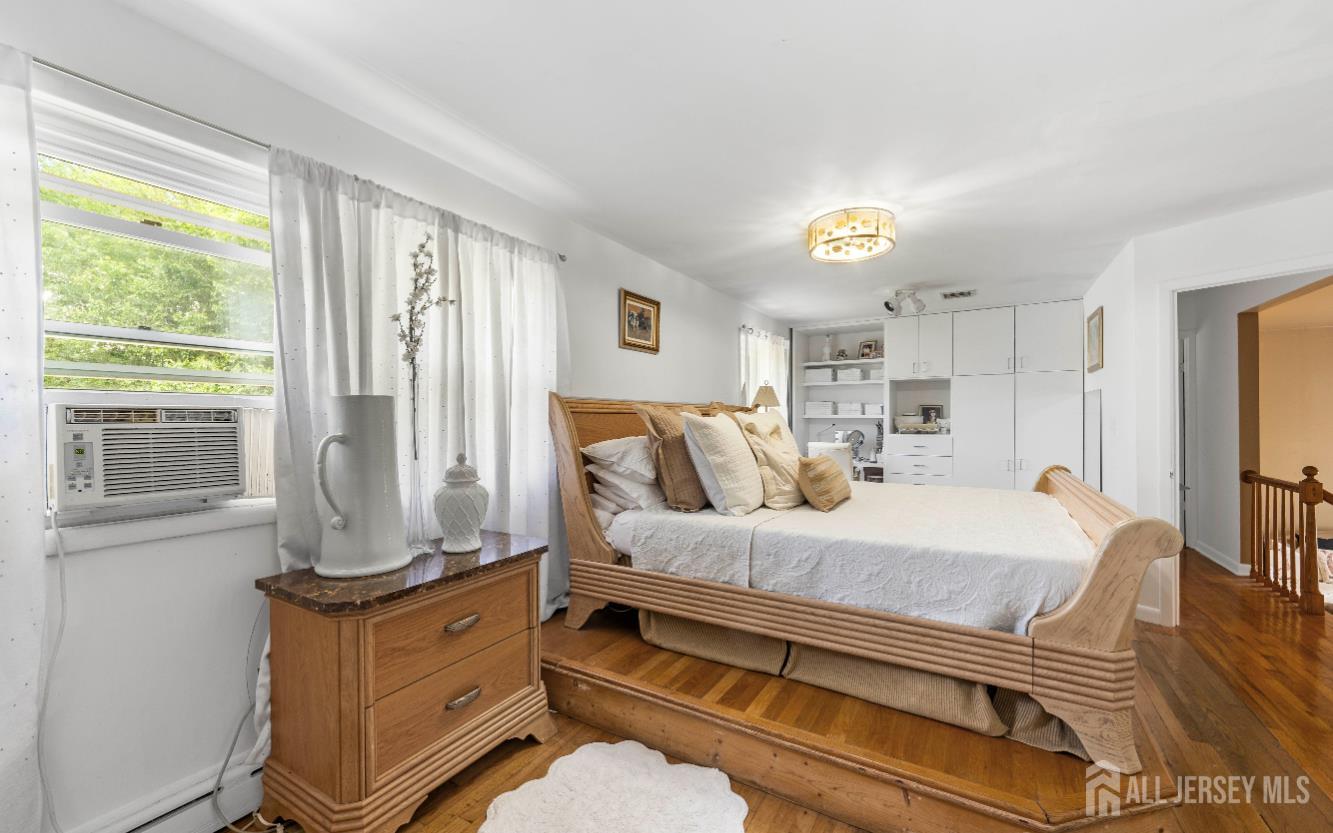 101 Weston Road Somerset, NJ 08873 - Photo 16 of 32 a bedroom with a bed and wooden floor