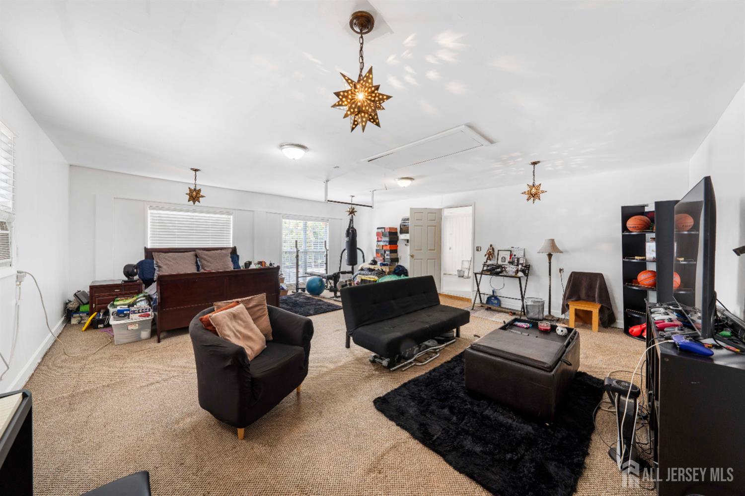 101 Weston Road Somerset, NJ 08873 - Photo 23 of 32 a living room with furniture and a chandelier