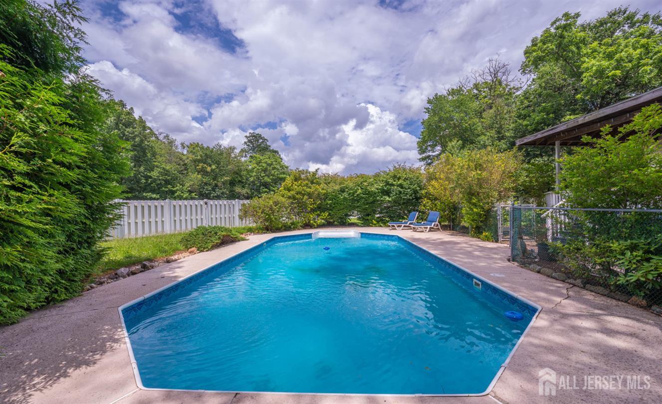 101 Weston Road Somerset, NJ 08873 - Photo 25 of 32 a view of a swimming pool with a yard