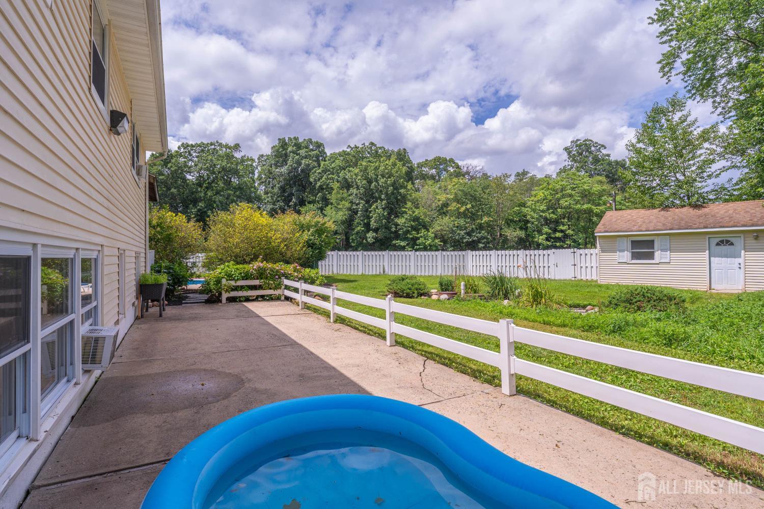 101 Weston Road Somerset, NJ 08873 - Photo 27 of 32 a view of a backyard with wooden fence