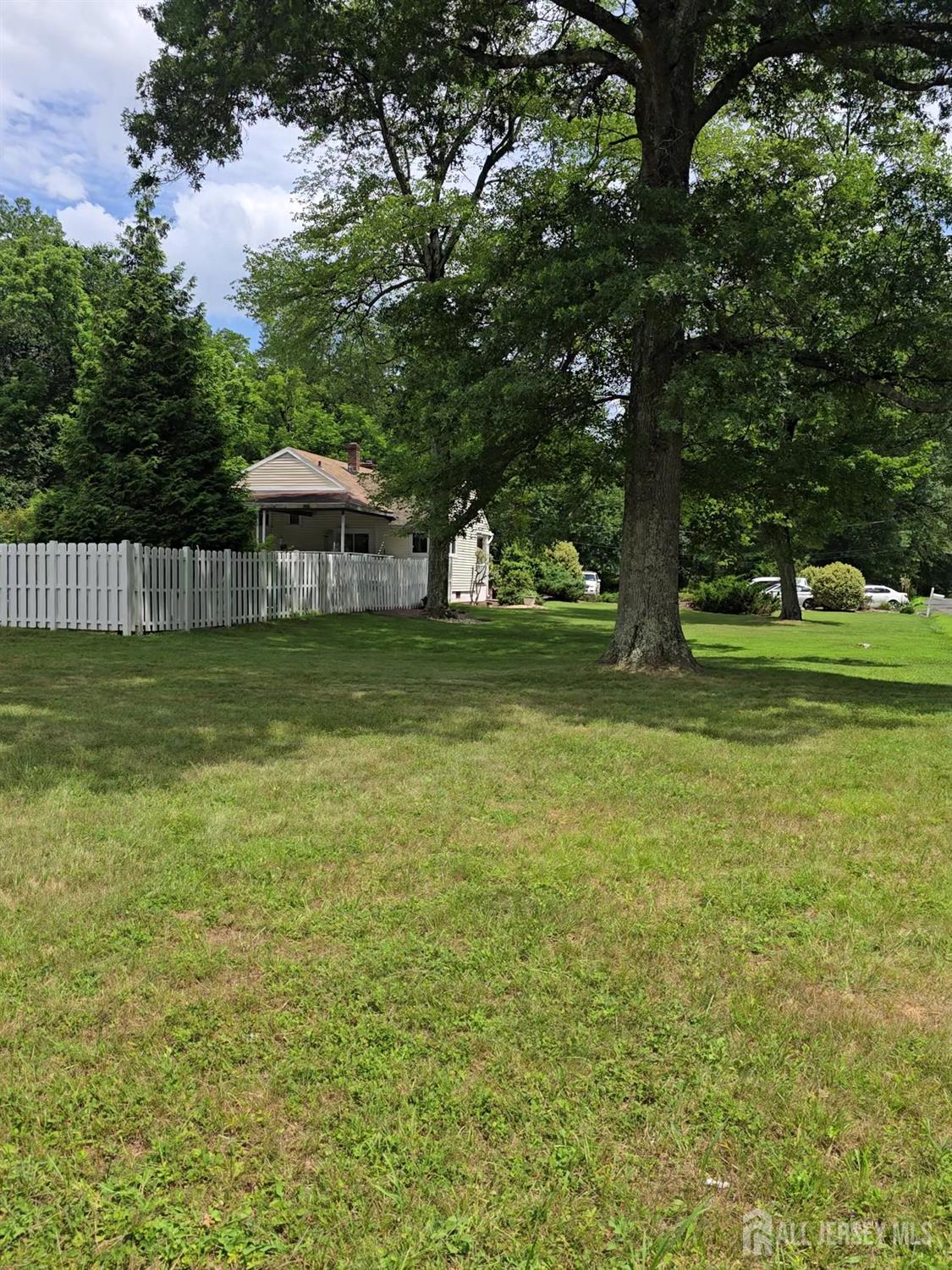 101 Weston Road Somerset, NJ 08873 - Photo 28 of 32 a backyard of a house with lots of green space and fountain
