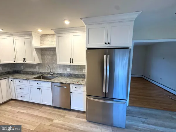 a kitchen with granite countertop stainless steel appliances and wooden cabinets