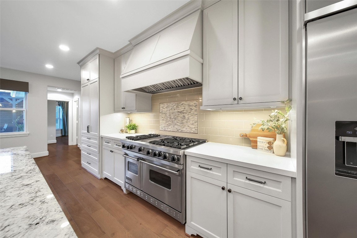 20730 Windrose Bend Drive Spring, TX 77379 - Photo 13 of 45 a kitchen with stainless steel appliances white cabinets and a stove