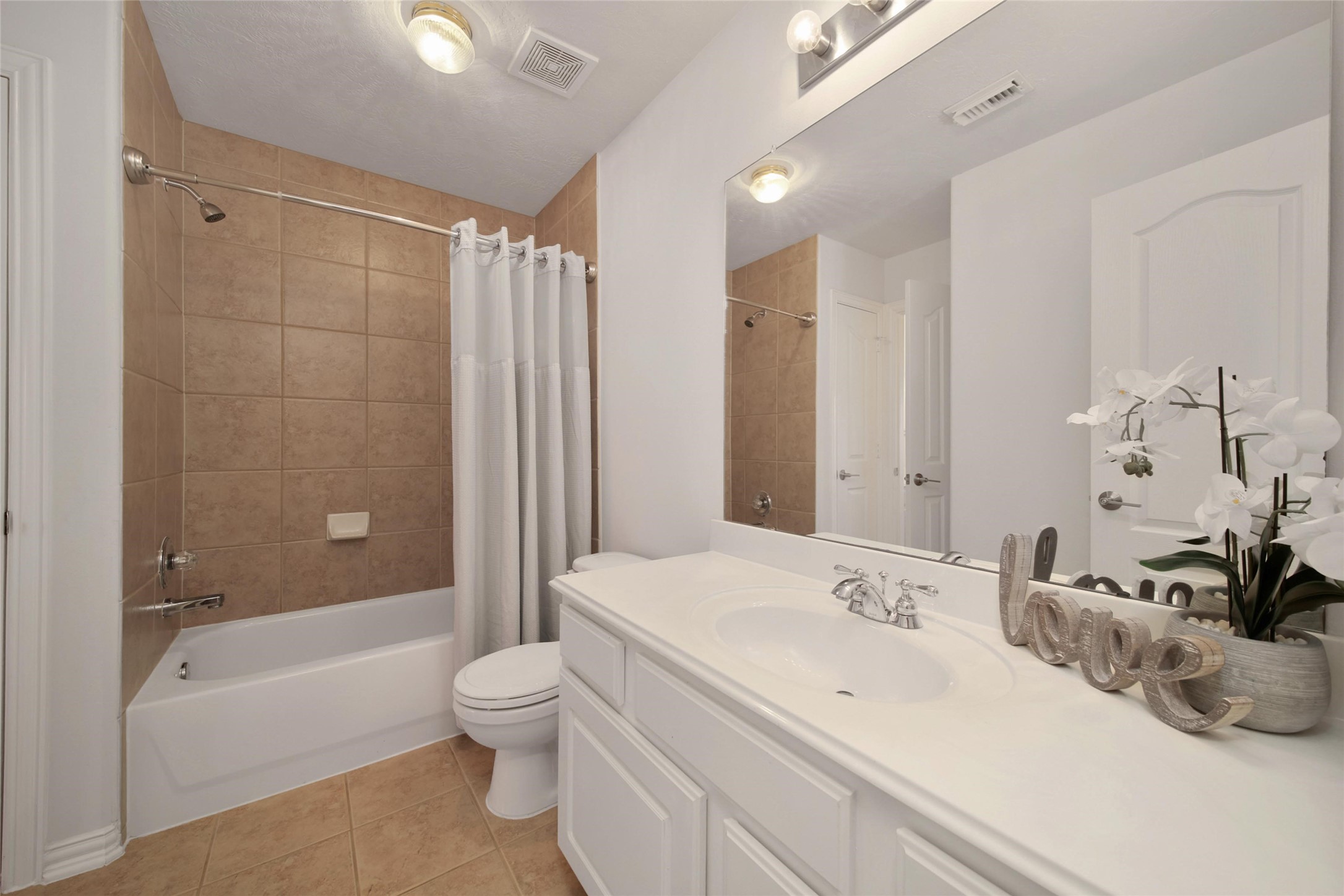 20730 Windrose Bend Drive Spring, TX 77379 - Photo 33 of 45 a bathroom with a bathtub shower sink vanity mirror and toilet