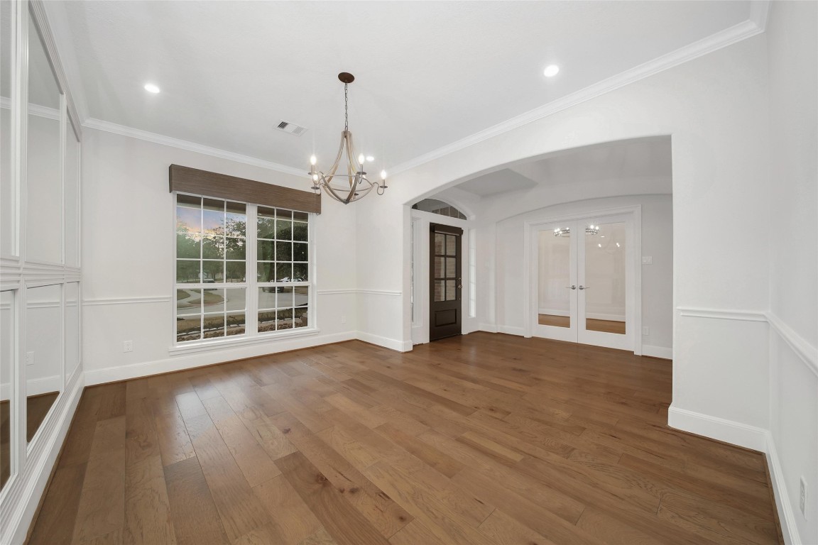 20730 Windrose Bend Drive Spring, TX 77379 - Photo 5 of 45 a view of an empty room with wooden floor and a window