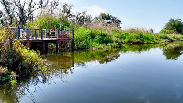 a view of a lake with a house in the background