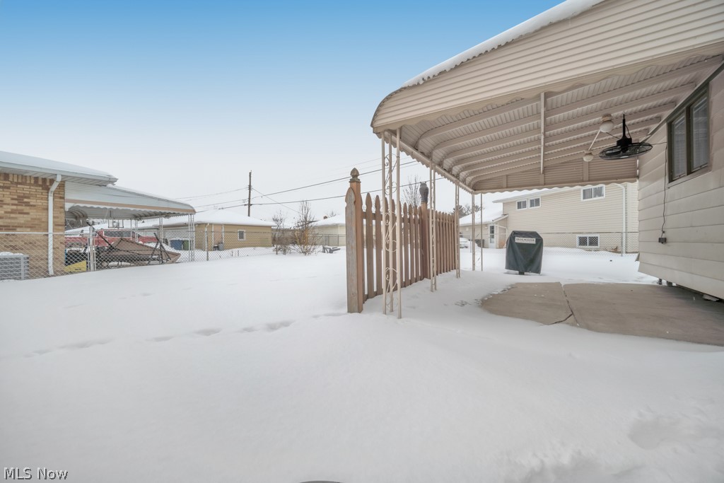 6846 Revere Road Cleveland, OH 44130 - Photo 7 of 30 Snowy yard featuring a ceiling fan