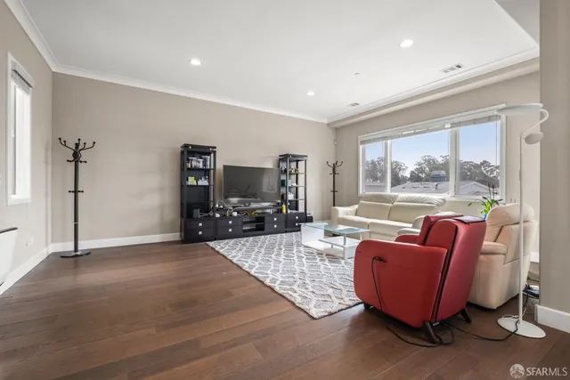 a living room with furniture a flat screen tv and a large window