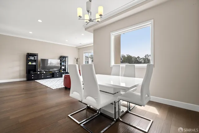 a view of a dining room with furniture window and wooden floor