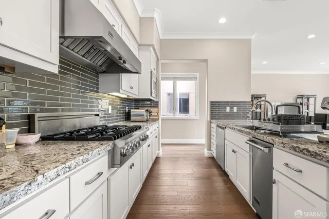 a kitchen with stainless steel appliances granite countertop a stove and a sink