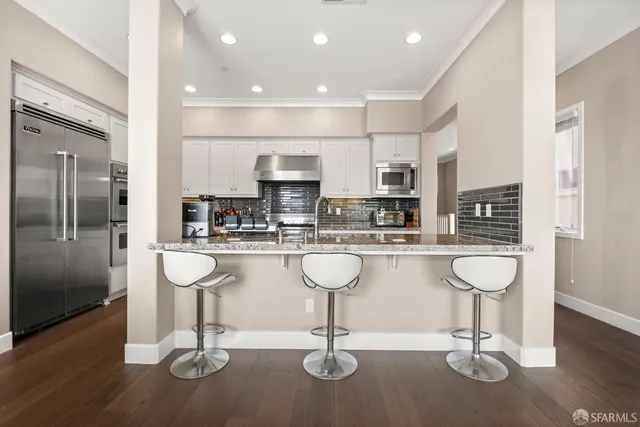 a kitchen with stainless steel appliances granite countertop a sink and cabinets