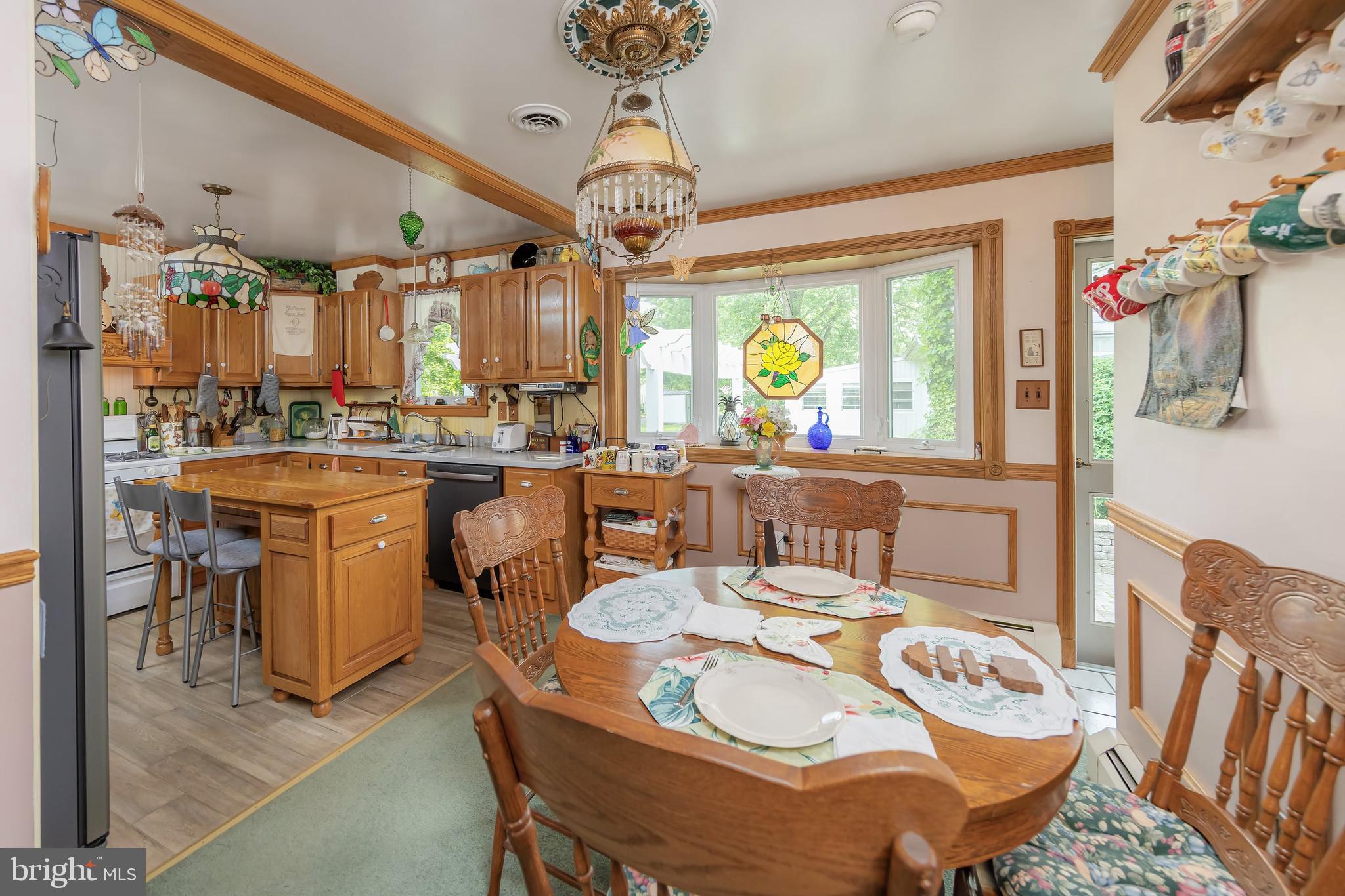 107 Elm Avenue Pitman, NJ 08071 - Photo 14 of 21 a dining room with furniture a chandelier and a rug