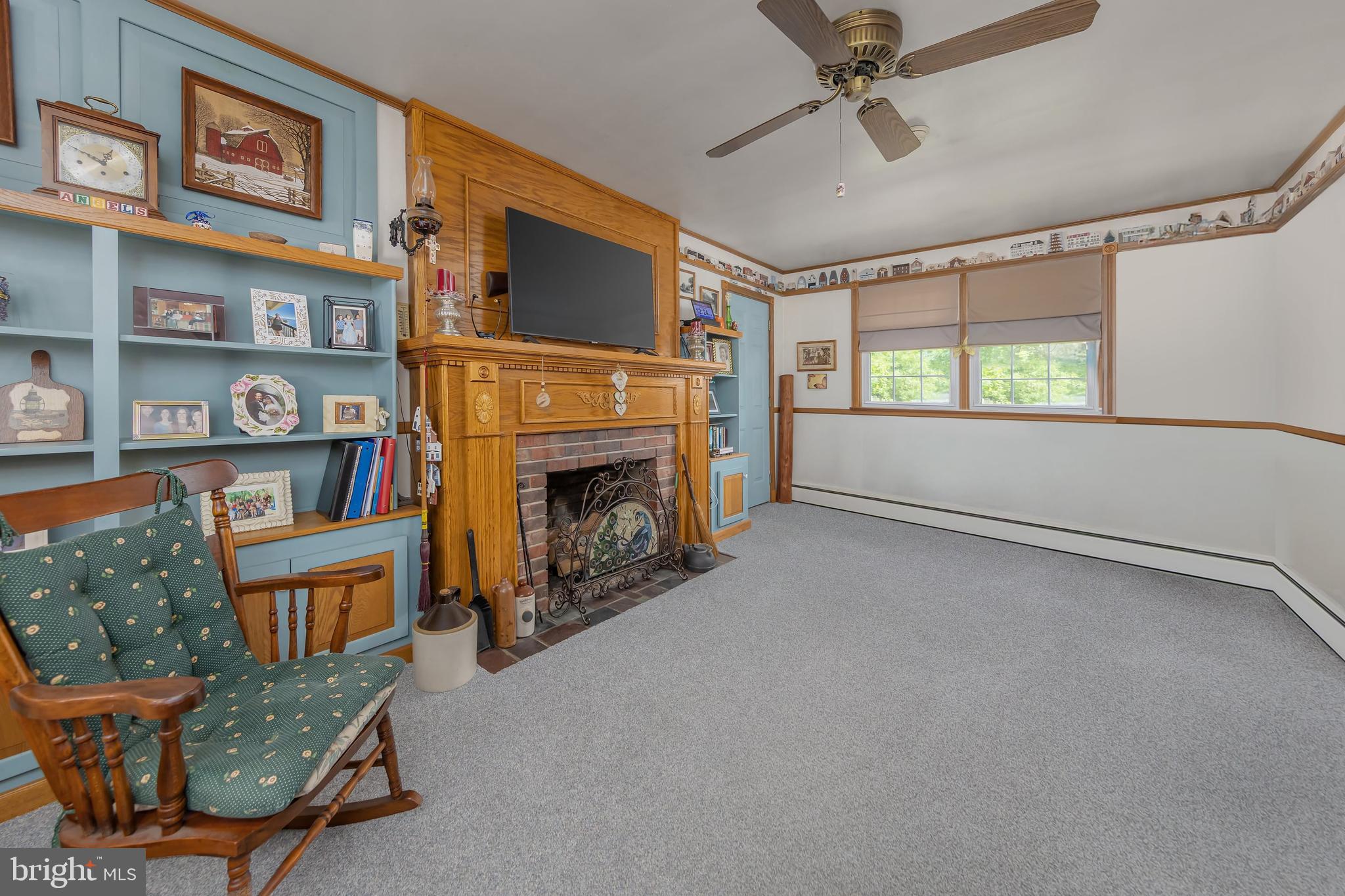 107 Elm Avenue Pitman, NJ 08071 - Photo 16 of 21 a living room with furniture a flat screen tv and a fireplace