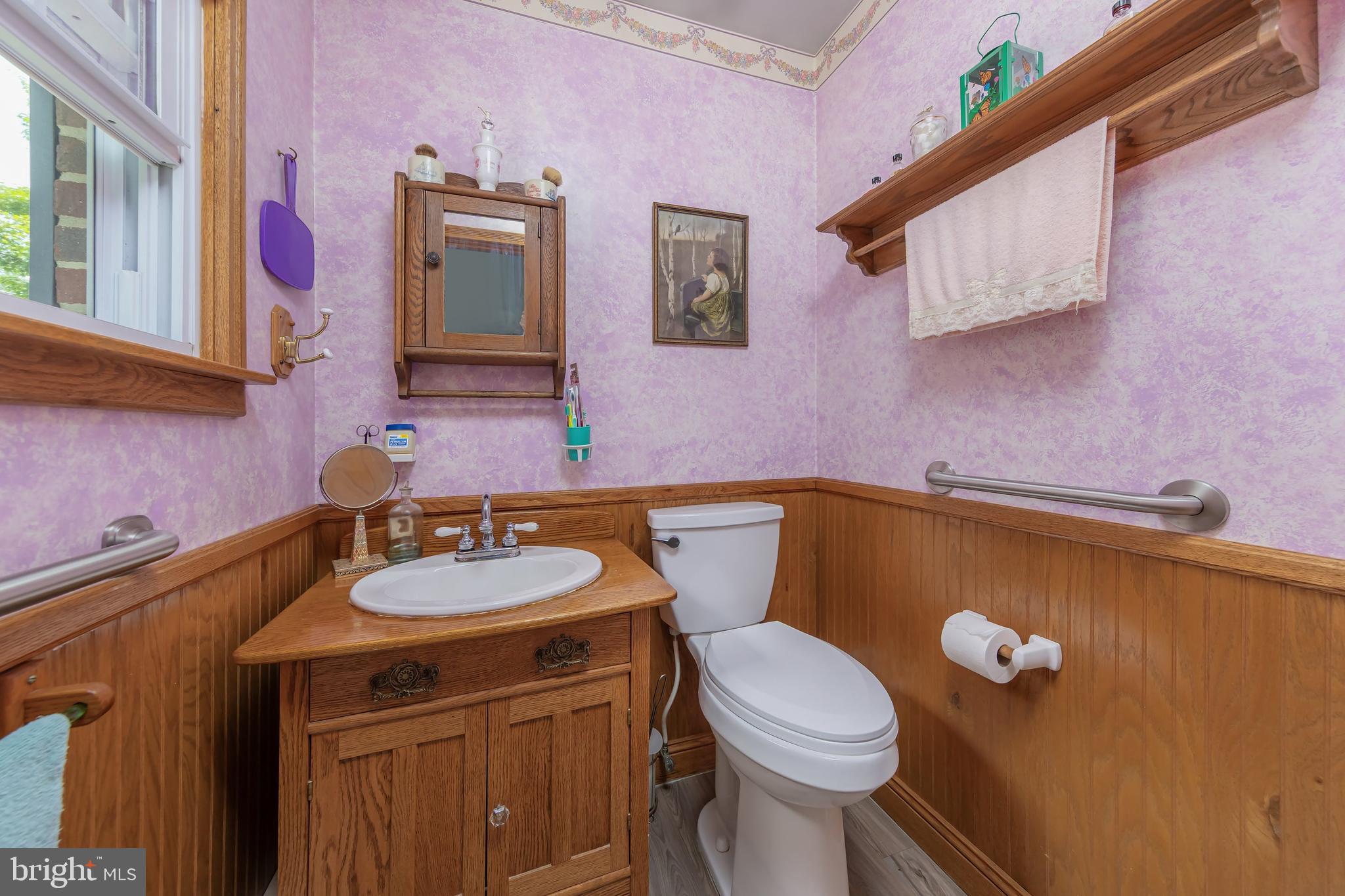 107 Elm Avenue Pitman, NJ 08071 - Photo 18 of 21 a bathroom with a sink a toilet and mirror