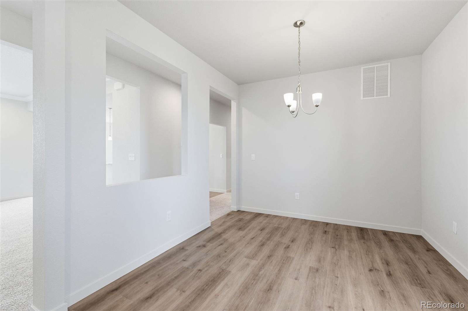 24515 Big Springs Road Peyton, CO 80831 - Photo 13 of 30 a view of a room with wooden floor and white walls