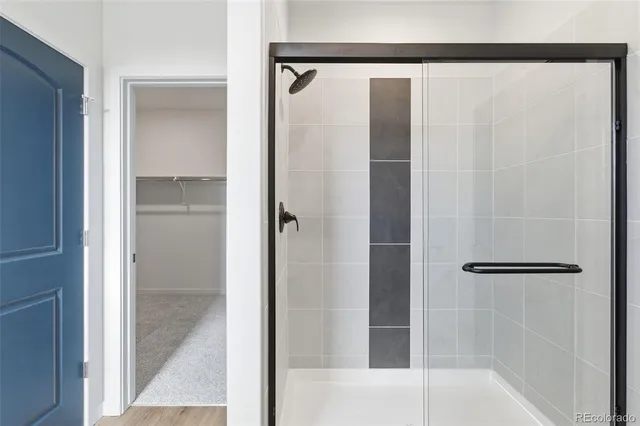 a bathroom with a glass shower door