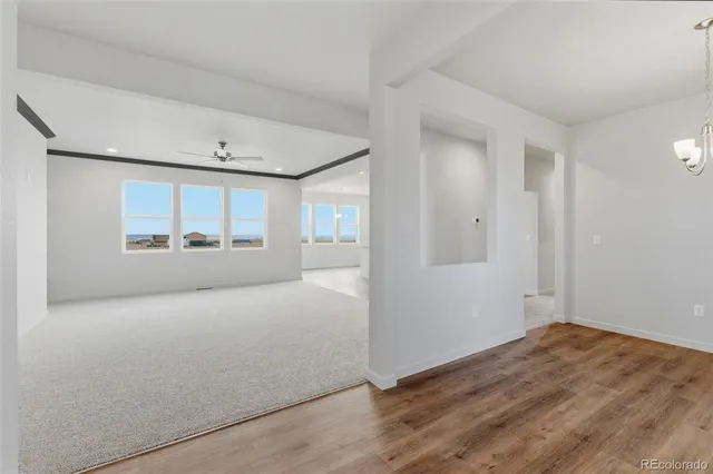 an empty room with window and mirror