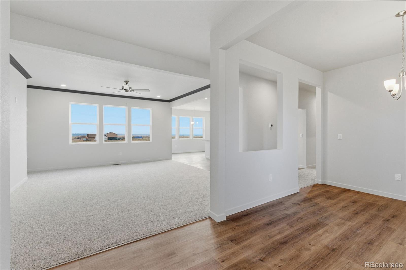 24515 Big Springs Road Peyton, CO 80831 - Photo 4 of 30 an empty room with window and mirror