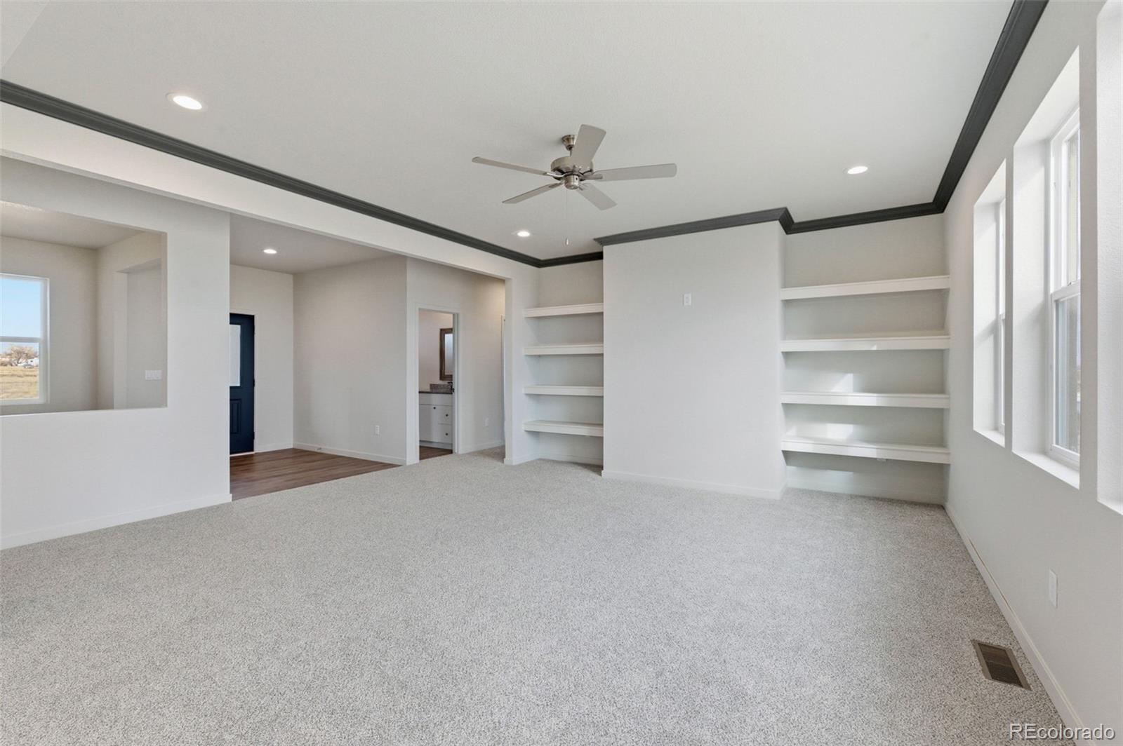 24515 Big Springs Road Peyton, CO 80831 - Photo 6 of 30 a view of an empty room with a window and a kitchen