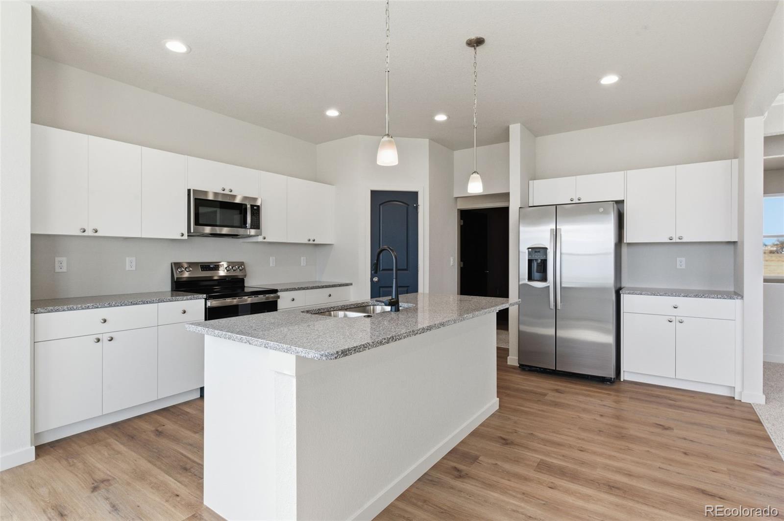 24515 Big Springs Road Peyton, CO 80831 - Photo 10 of 30 a kitchen with stainless steel appliances a refrigerator sink and microwave