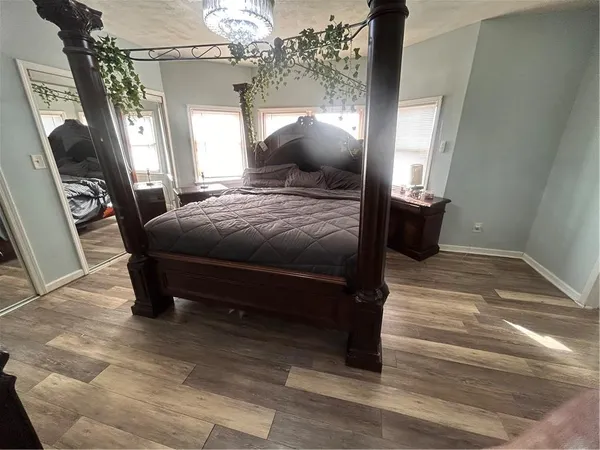 a bedroom with furniture and a mirror