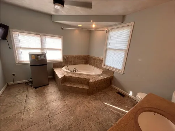 a bathroom with a toilet sink and mirror